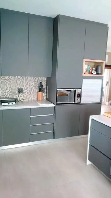 Kitchen: grey units, white tops and an open display niche