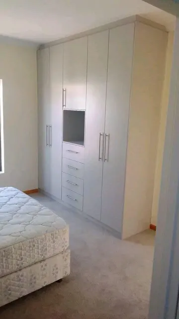 Built-in wardrobe with drawers and a TV niche