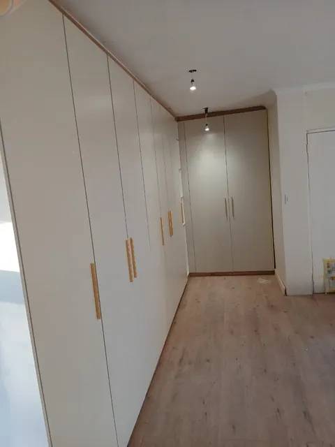 Built-in wardrobes with timber handles